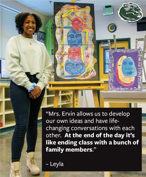 Wood River High School student standing next to her artwork 